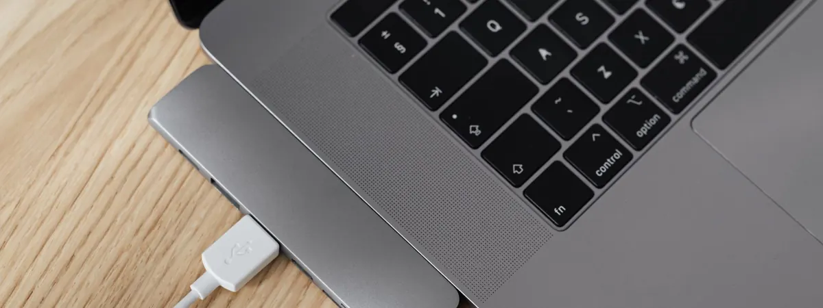 Laptop with a USB hub on a wooden desk